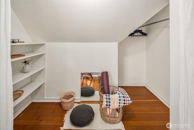 walk in closet with hardwood / wood-style floors and lofted ceiling