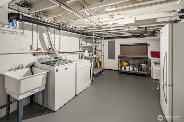 clothes washing area with electric panel, laundry area, and separate washer and dryer