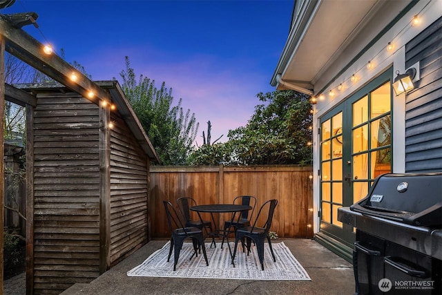 view of patio / terrace featuring outdoor dining area, french doors, and fence