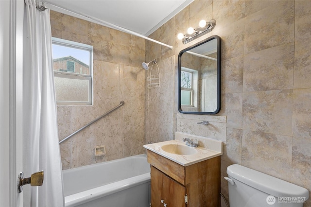 bathroom with shower / bath combo with shower curtain, toilet, tile walls, and vanity