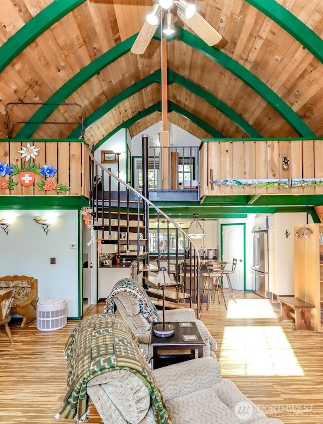 living area featuring wood ceiling, stairs, ceiling fan, and wood finished floors