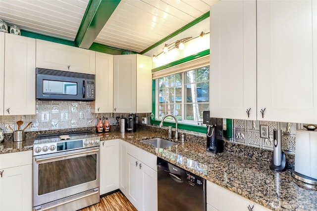 kitchen with stainless steel range with electric stovetop, a sink, tasteful backsplash, black microwave, and dishwashing machine