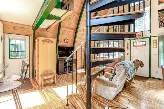 stairway featuring wood walls and wood finished floors