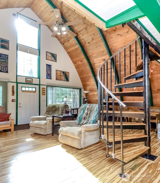 living room featuring stairs, wood finished floors, plenty of natural light, and wood ceiling