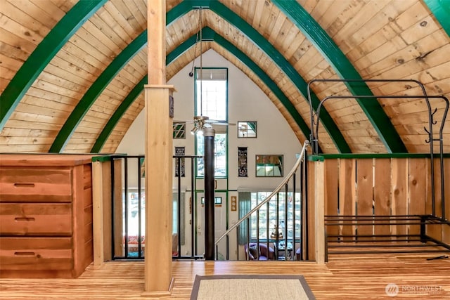 interior space with beamed ceiling, wooden ceiling, and wood finished floors