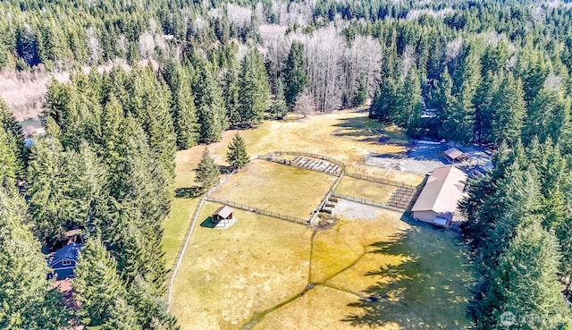 birds eye view of property with a view of trees