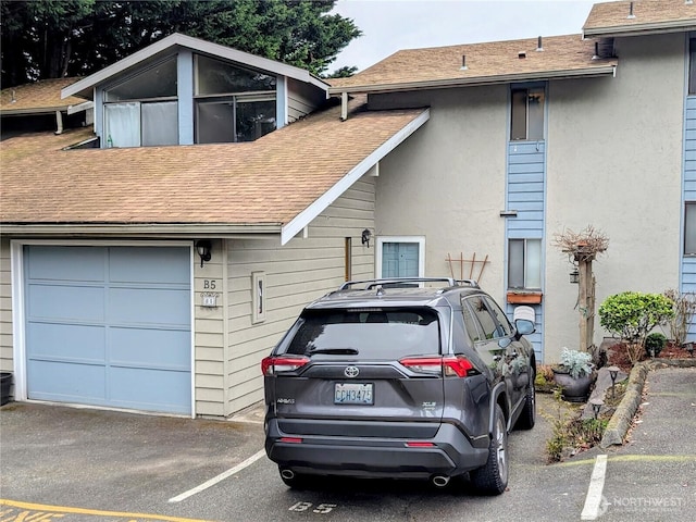 view of front of property featuring stucco siding and a shingled roof