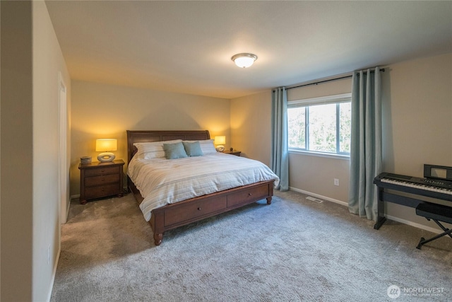 bedroom with baseboards and carpet