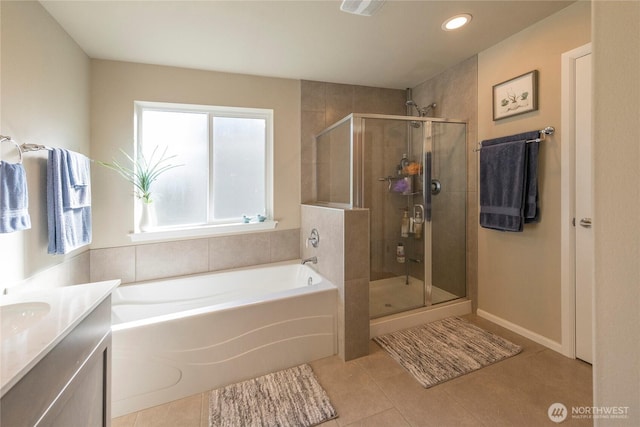 bathroom with a bath, tile patterned floors, a stall shower, and vanity