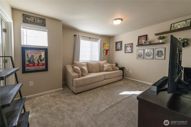 living area featuring visible vents, baseboards, and carpet floors