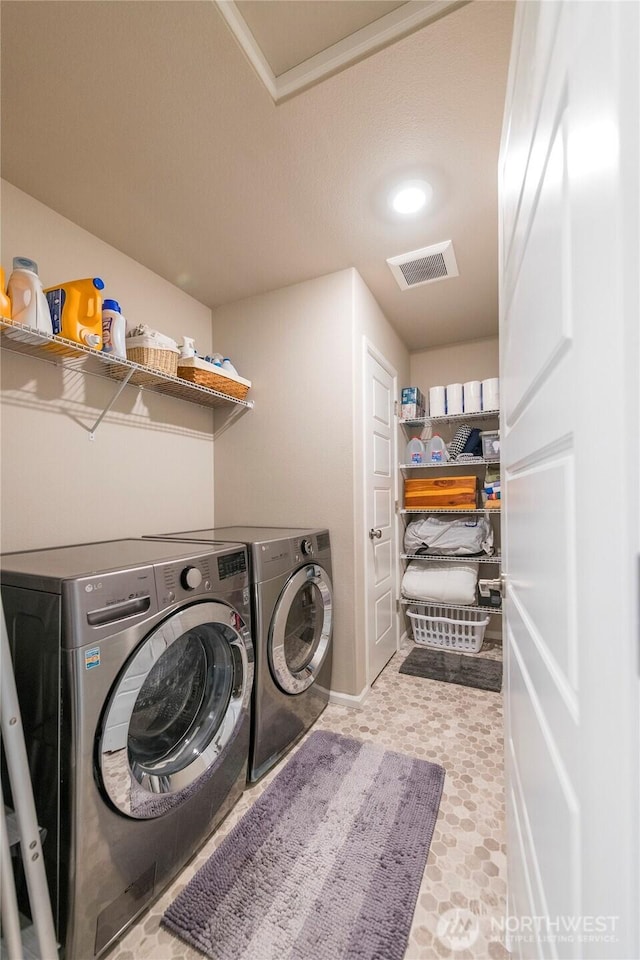 laundry room featuring laundry area, visible vents, and washer and clothes dryer