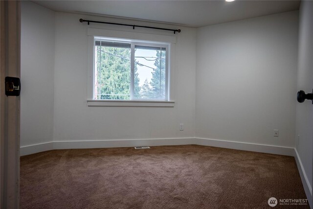 carpeted empty room featuring visible vents and baseboards