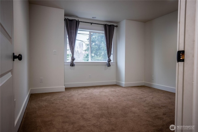 carpeted empty room with baseboards