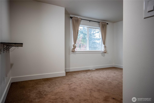 carpeted empty room with visible vents and baseboards