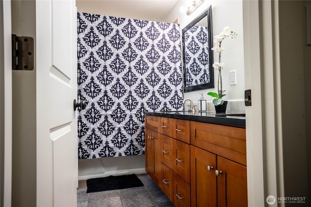 bathroom featuring vanity and curtained shower