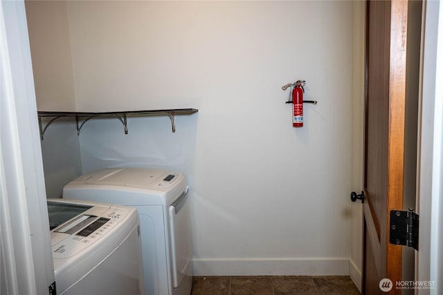 washroom with tile patterned flooring, laundry area, baseboards, and separate washer and dryer