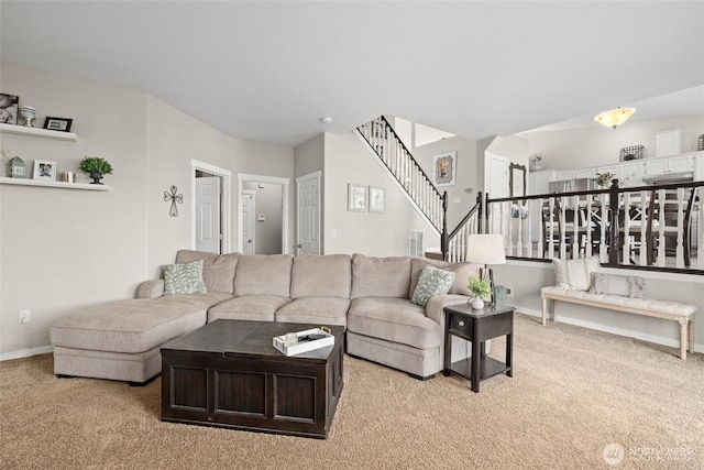 carpeted living room featuring stairs and baseboards