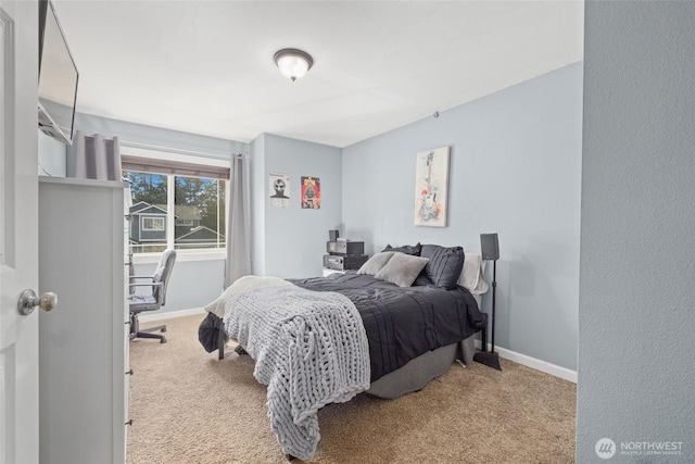 bedroom with carpet and baseboards