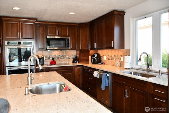 kitchen featuring a sink, tasteful backsplash, and appliances with stainless steel finishes