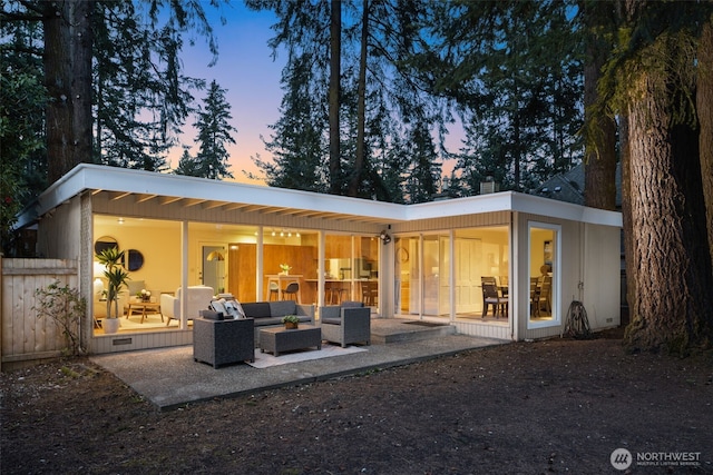 rear view of house with crawl space, outdoor lounge area, and a patio