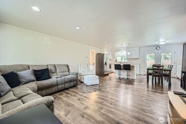 living area featuring french doors and light wood-style floors