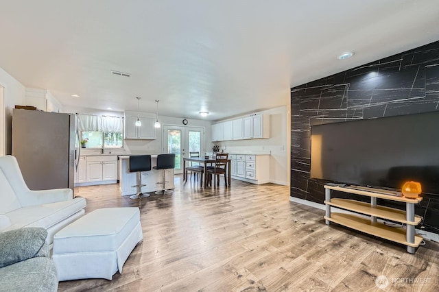 living room with visible vents and light wood finished floors