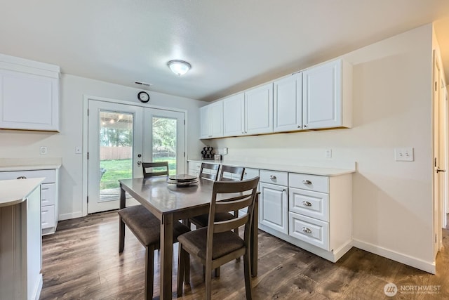 dining area with dark wood-style floors, french doors, and baseboards