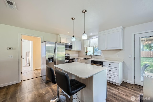 kitchen with visible vents, dark wood-type flooring, white cabinets, light countertops, and appliances with stainless steel finishes