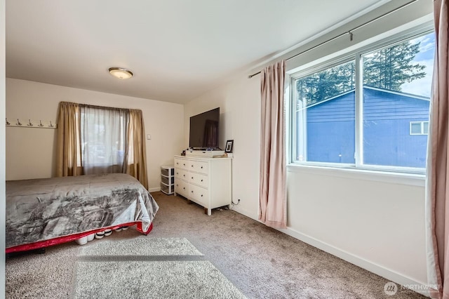 bedroom featuring carpet and baseboards