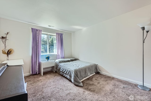 carpeted bedroom with visible vents and baseboards