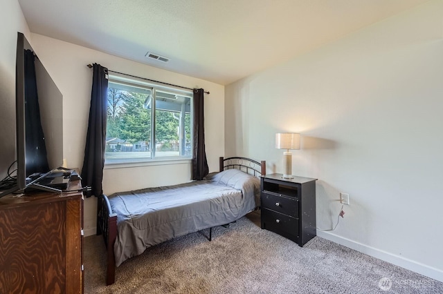 carpeted bedroom with baseboards and visible vents