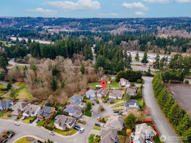 birds eye view of property with a residential view and a forest view