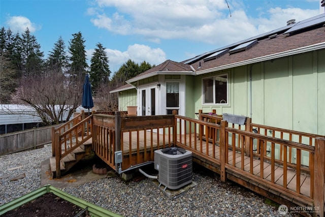 deck featuring central air condition unit, french doors, and fence