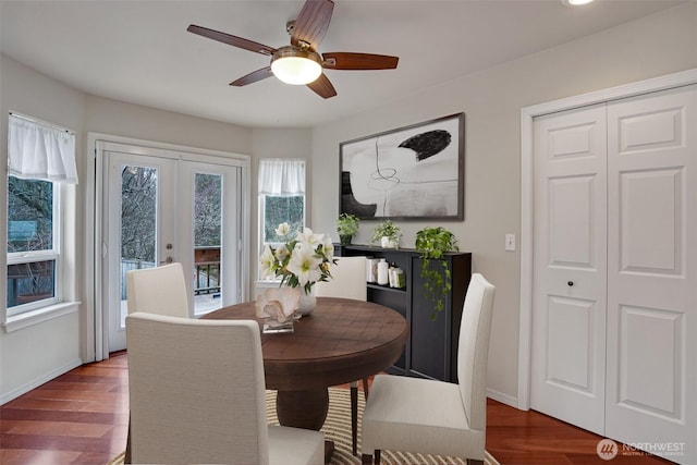 dining space with french doors, baseboards, ceiling fan, and wood finished floors