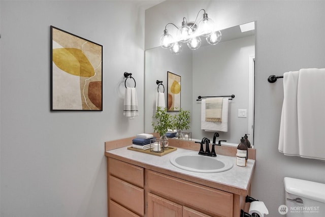 half bathroom featuring toilet and vanity