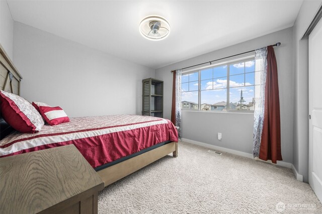 carpeted bedroom with visible vents and baseboards