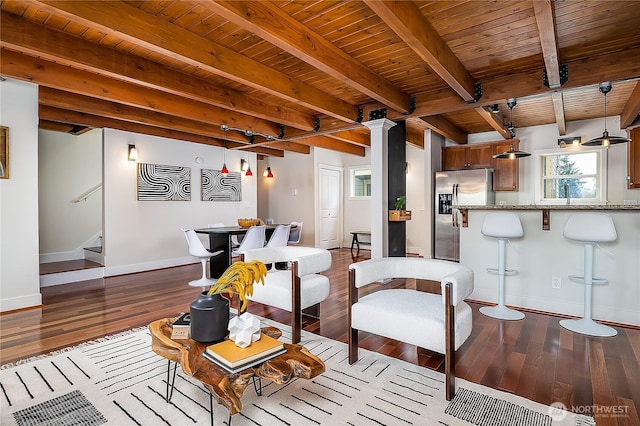 living room featuring beamed ceiling, dark wood-type flooring, stairway, baseboards, and wood ceiling