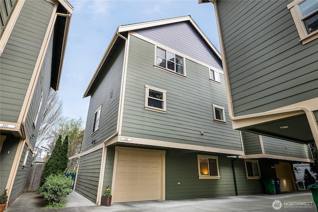 rear view of property featuring an attached garage