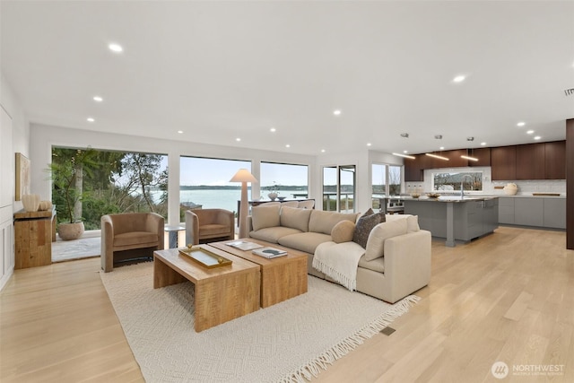 living room with recessed lighting and light wood finished floors