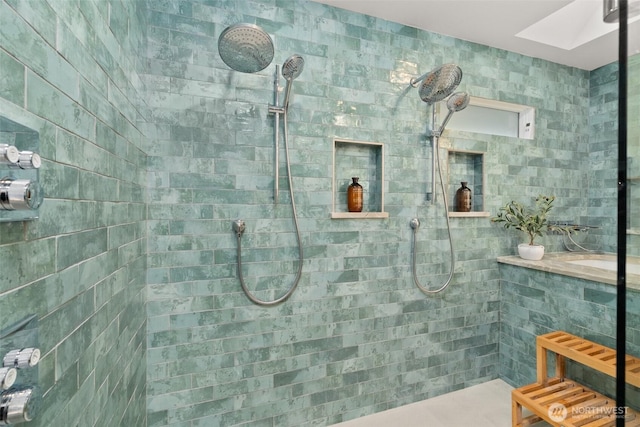 full bath with a skylight and tiled shower