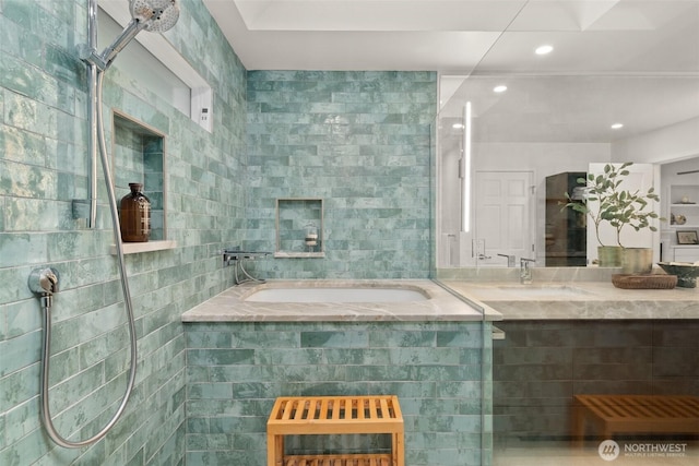 full bathroom featuring recessed lighting, a garden tub, tile walls, and vanity