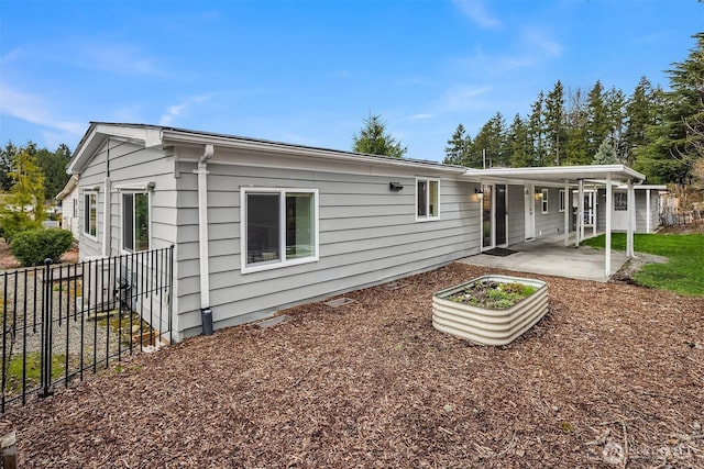 rear view of property with a patio and fence