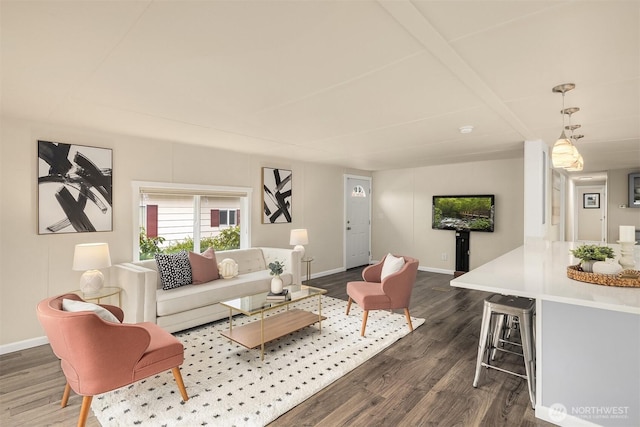 living room featuring baseboards and dark wood-type flooring