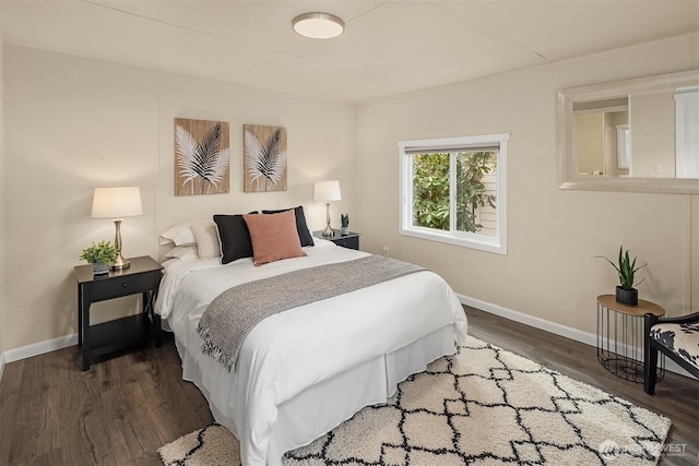 bedroom with baseboards and wood finished floors