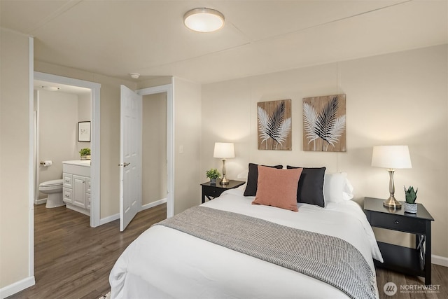 bedroom featuring ensuite bathroom, baseboards, and wood finished floors