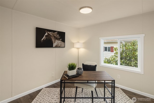 office with dark wood-style floors and baseboards