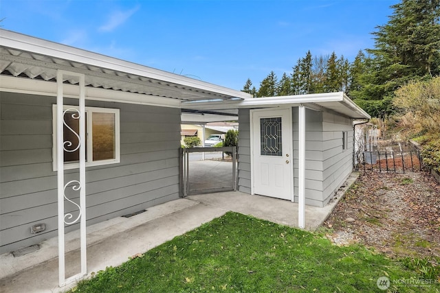 exterior space with an outdoor structure, a gate, and fence