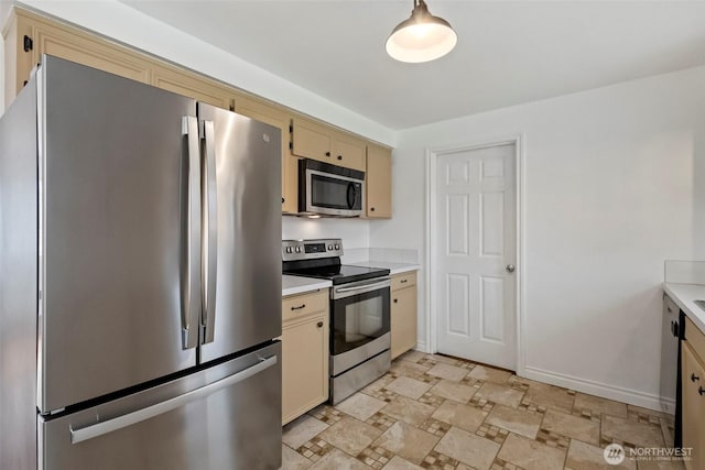 kitchen with cream cabinets, appliances with stainless steel finishes, and light countertops