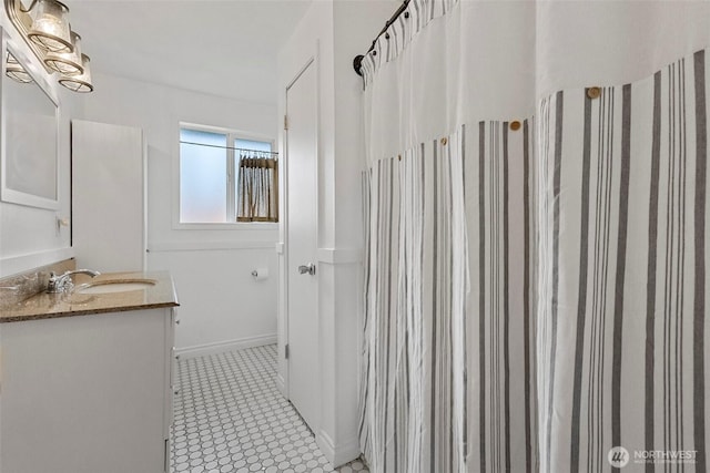 bathroom featuring tile patterned floors, vanity, and baseboards