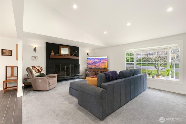 living room with visible vents, recessed lighting, a fireplace, and baseboards